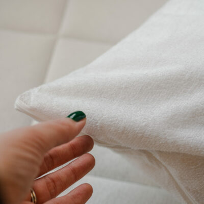 Waterproof Pillow Protector_with Models hand_45th St Bedding